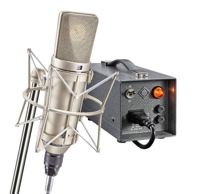 Large diaphragm condenser microphone in shock mount with metal power supply box featuring on/off switch and knobs