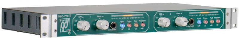 Rack-mounted audio preamplifier with knobs, switches, and input jacks on a green front panel.