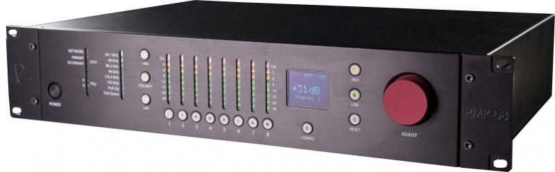 Black rackmount audio equipment with buttons, LED meters, a screen, and a red rotary knob.