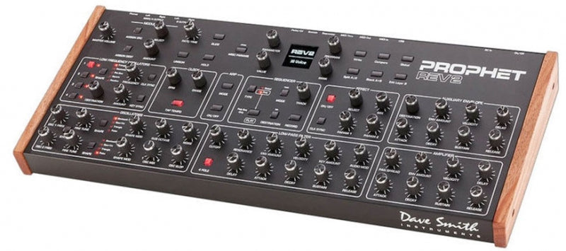 Black synthesizer module with multiple knobs, switches, and wooden side panels labeled Prophet Rev2.