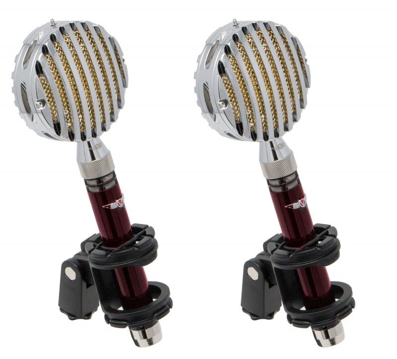 Two vintage-style microphones with red bodies, silver grille covers, and black shock mounts are shown side by side.