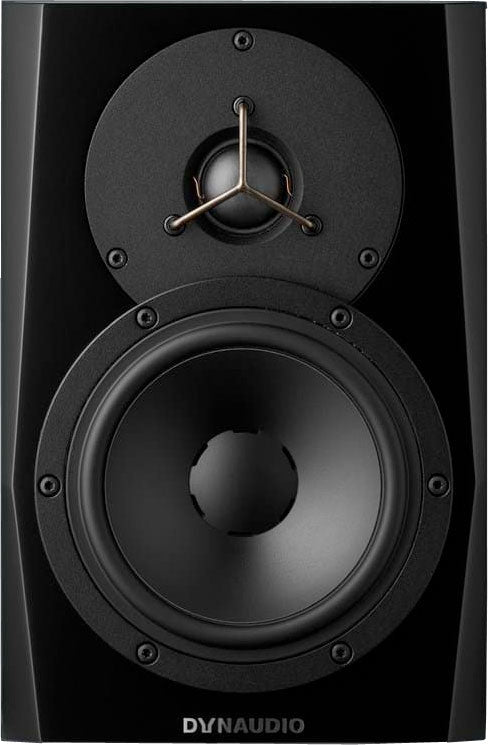 Black speaker with two drivers and DYNAUDIO logo on front panel.