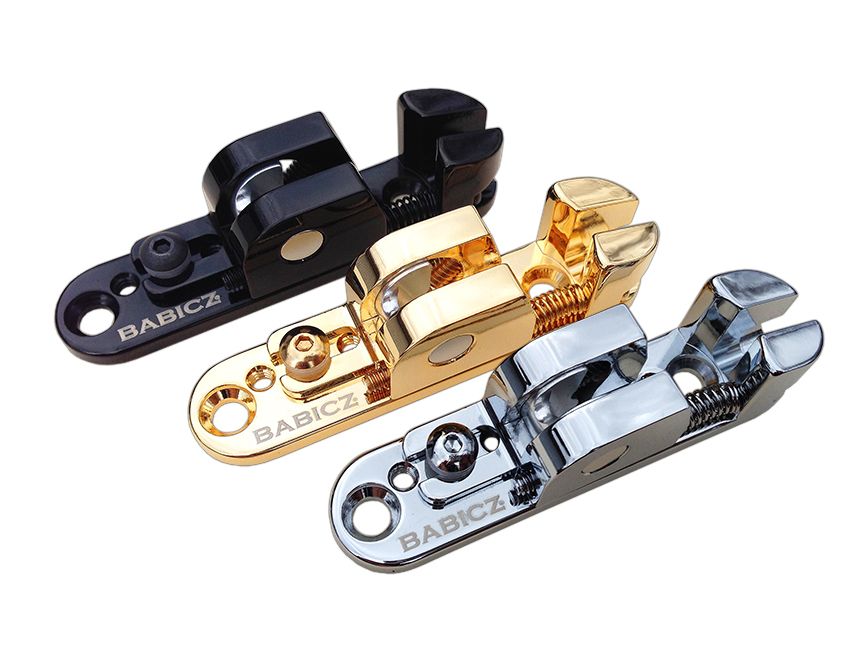 Three individual bass saddles in black, gold, and silver metal finishes with springs and mounting holes.