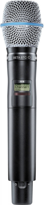 Handheld microphone with metal mesh grille, digital display showing Channel 1, and power switch.