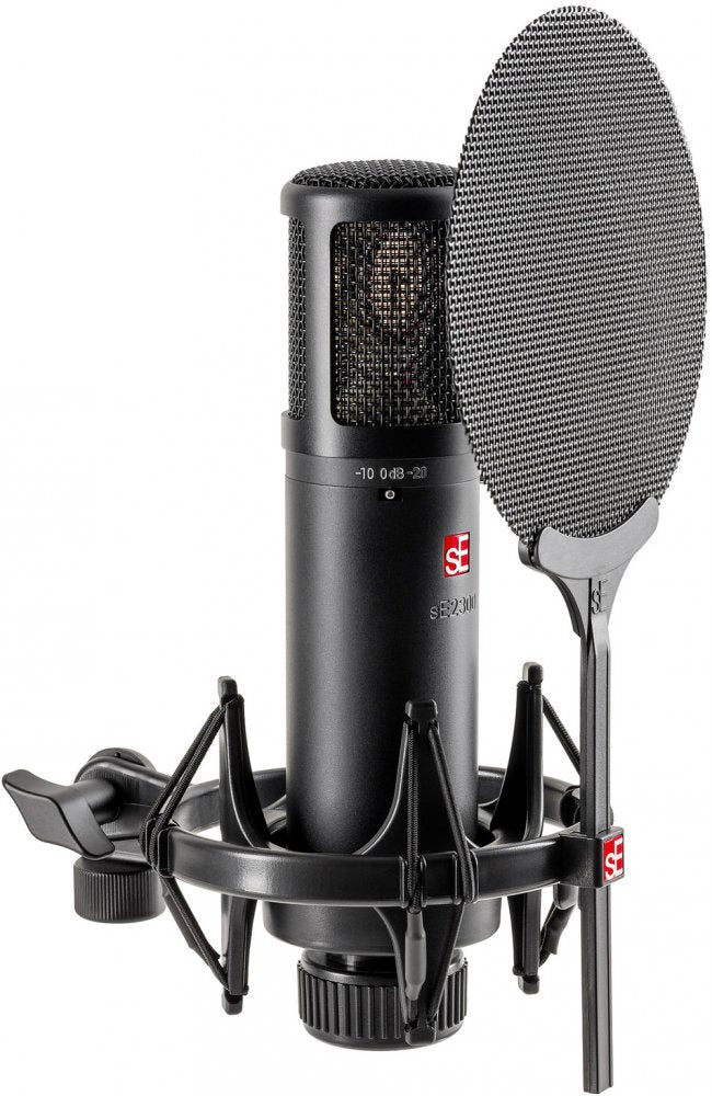 Black condenser microphone with shock mount and pop filter against white background.