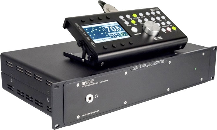 Black GRACE m908 reference monitor controller with control panel featuring rotary knob, buttons, and a color display.