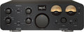 Front view of a black SPL Phonitor xe audio headphone amplifier with multiple control knobs, switches, meters, and headphone jacks.