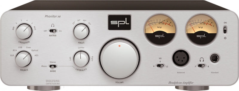 Silver audio amplifier front panel with rotary dials, toggle switches, VU meters, and headphone outputs.