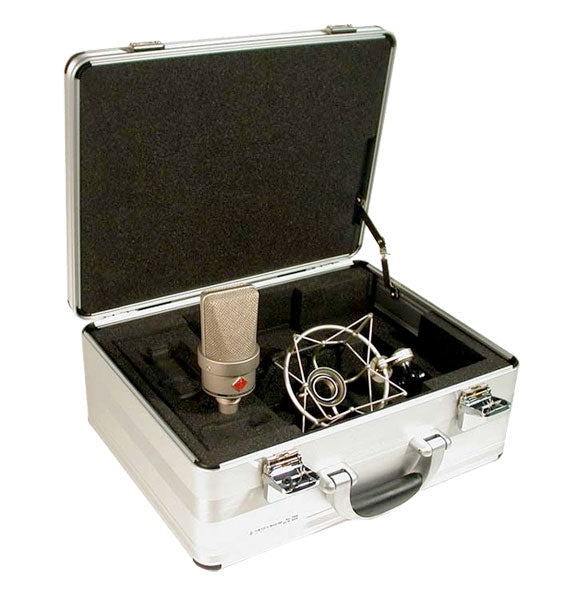 Silver microphone and shock mount inside an open silver carrying case with foam padding.