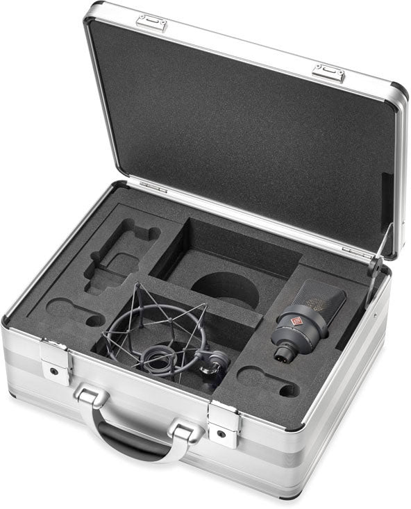 Open silver carrying case with black foam insert holding a black microphone with a shock mount inside.