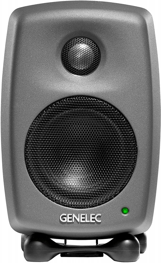 Front view of a gray Genelec studio monitor speaker with black speaker grilles and a green indicator light.