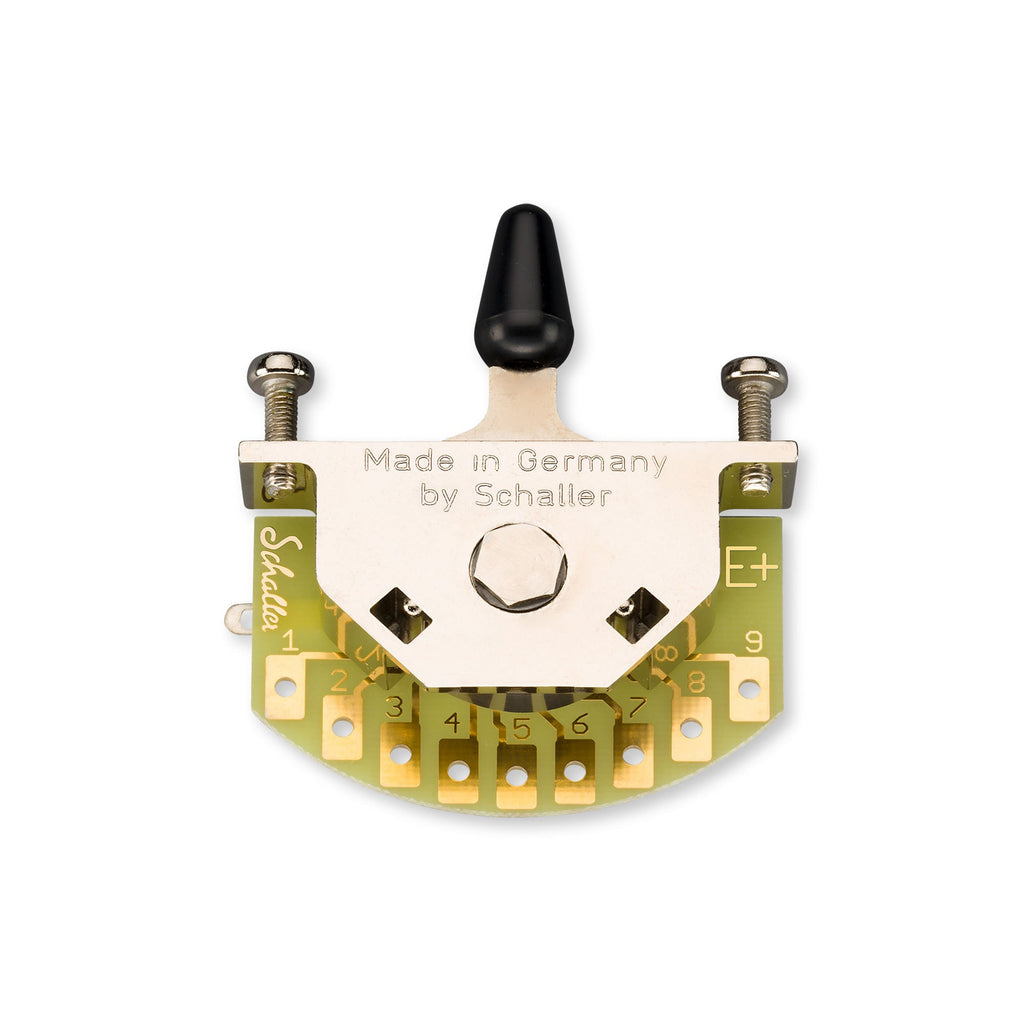 Top view of a Schaller toggle switch mounted on a semi-circular circuit board with nine solder lugs and a black lever.