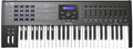 Black 49-key MIDI controller keyboard with pads, knobs, wheels, and an LCD screen in the center.