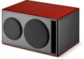 Black studio monitor speaker with brown wooden top and sides, featuring two round fabric-covered drivers on front.