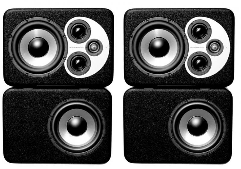 Front view of four black rectangular speakers, two smaller with multiple drivers and two larger subwoofers.