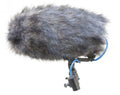 Shotgun microphone covered with gray furry windscreen mounted on a shock mount with attached blue cable.
