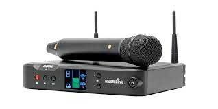 Wireless handheld microphone and receiver unit with digital display and antennae on a white background.