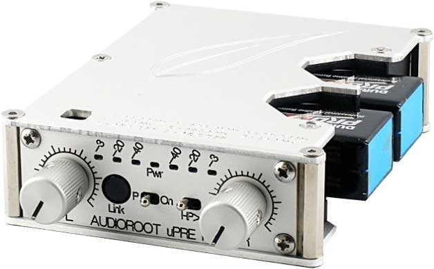 White and silver audio device with two rotary knobs and fiber optic connectors on one side
