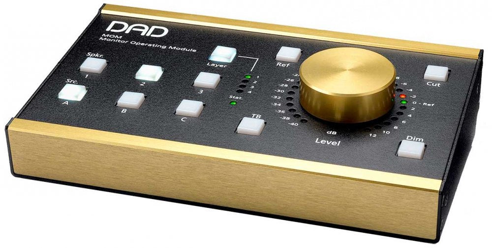Black and gold monitor operation module with push buttons and a large gold rotary knob.