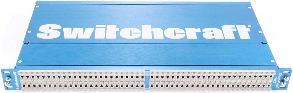 Blue metal Switchcraft panel with two rows of 1/4 inch jack sockets arranged in 48 pairs.
