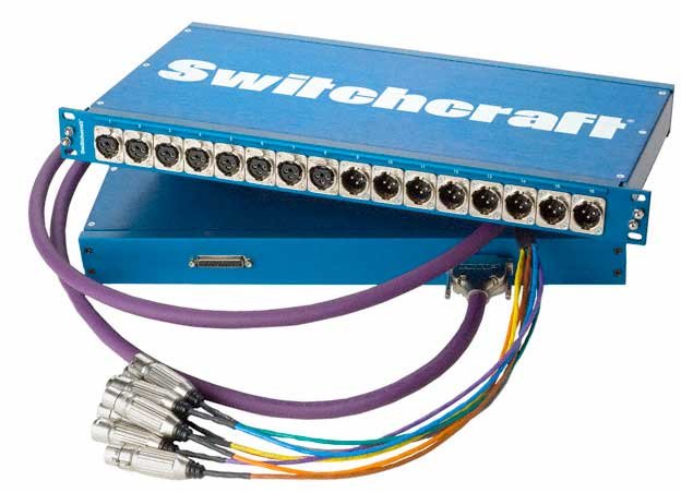 Blue patchbay unit with multiple circular connectors and attached multi-colored cables with metal connectors.