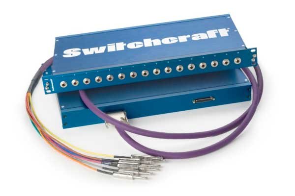 Blue Switchcraft patchbay unit with multiple 1/4-inch jack sockets and attached multi-conductor cables.