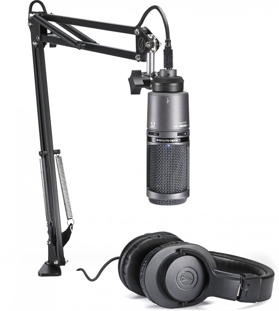 Black Audio-Technica microphone on adjustable arm with USB connector and black headphones beside it.
