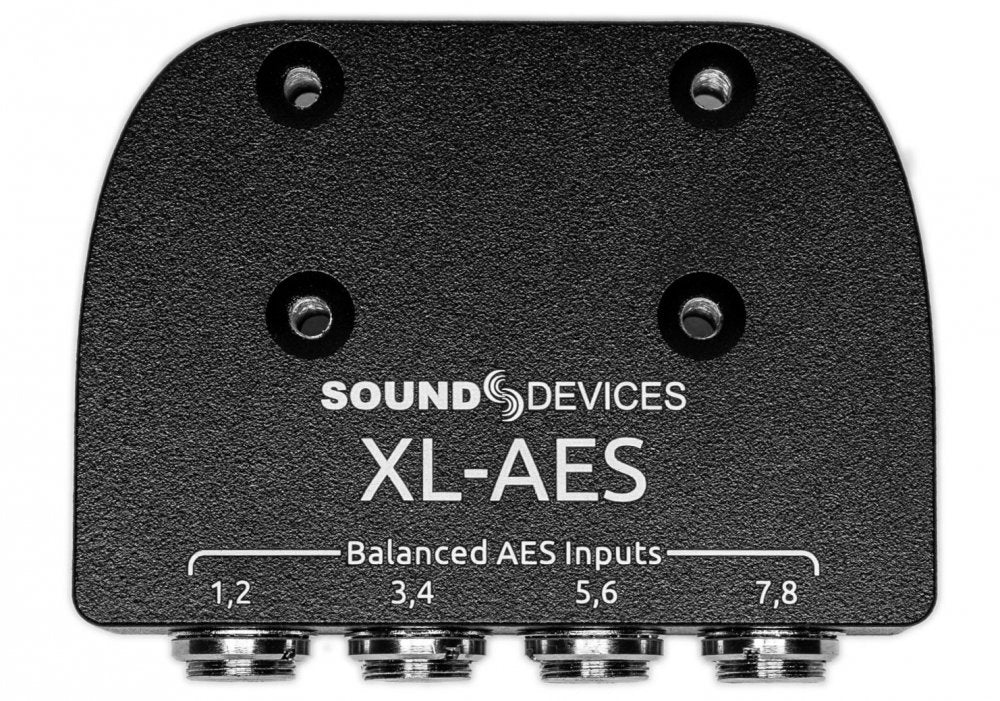 Black metal audio device panel with four balanced AES input connectors labeled 1-8.