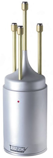 Silver cylindrical device with four gold vertical rods and small cylindrical connectors on top, labeled TRINNOV PRIMIZER.