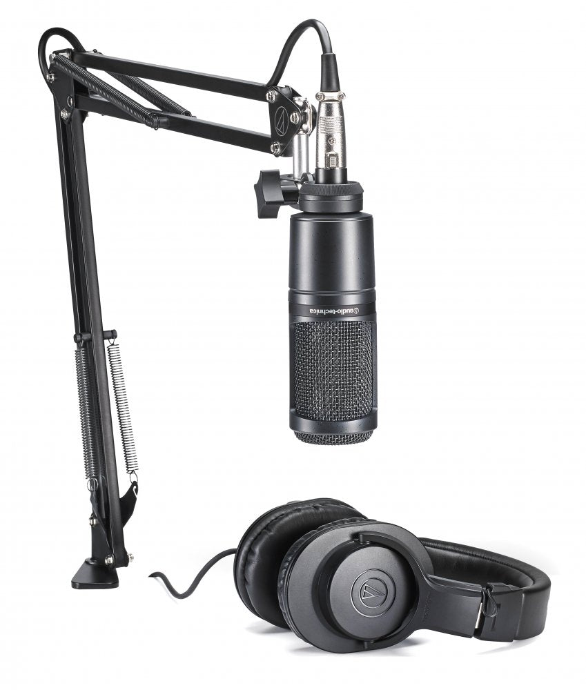 Black microphone on adjustable arm stand and pair of black over-ear headphones on white background