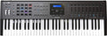 Black MIDI controller keyboard with 61 keys, pads, knobs, buttons, and a central display screen showing a preset.