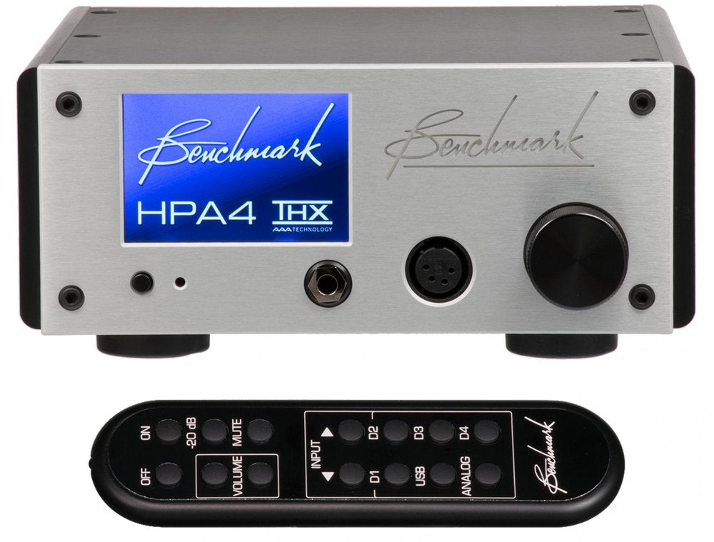 Silver Benchmark HPA4 headphone amplifier with blue display and black remote control with labeled buttons.