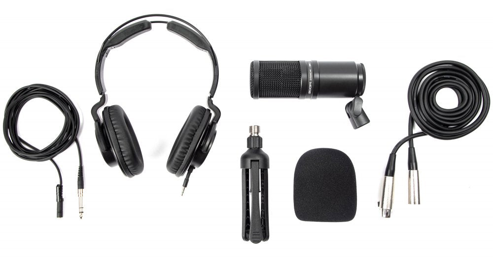 Black studio microphone with mount, headphones, foam windscreen, tripod, and cables on white background.