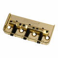 Gold colored metal guitar bridge with three brass saddles and adjustment screws, labeled Wilkinson.