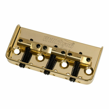 Gold colored metal guitar bridge with three brass saddles and adjustment screws, labeled Wilkinson.