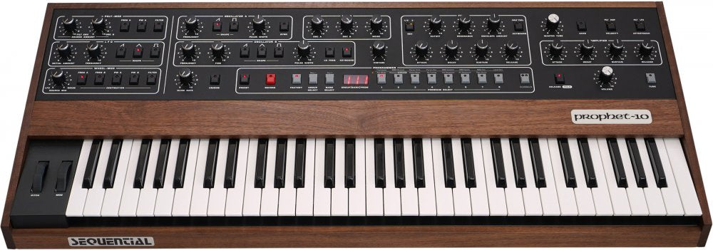 Keyboard synthesizer with wooden side panels and multiple knobs, buttons, and pitch/mod wheels on top control panel.