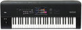 Black keyboard synthesizer with 61 keys, touchscreen, joystick, wheel, knobs, and buttons.
