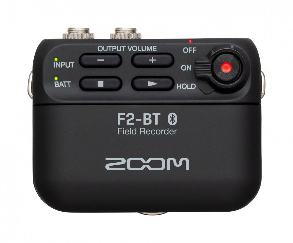 Black field recorder device with volume controls, input and battery indicators, and two metal connectors on top.
