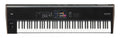 Black and white 88-key synthesizer keyboard with touchscreen and control buttons on top panel.