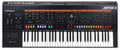 Black keyboard synthesizer with labeled control sections, knobs, sliders, buttons, and a digital display.