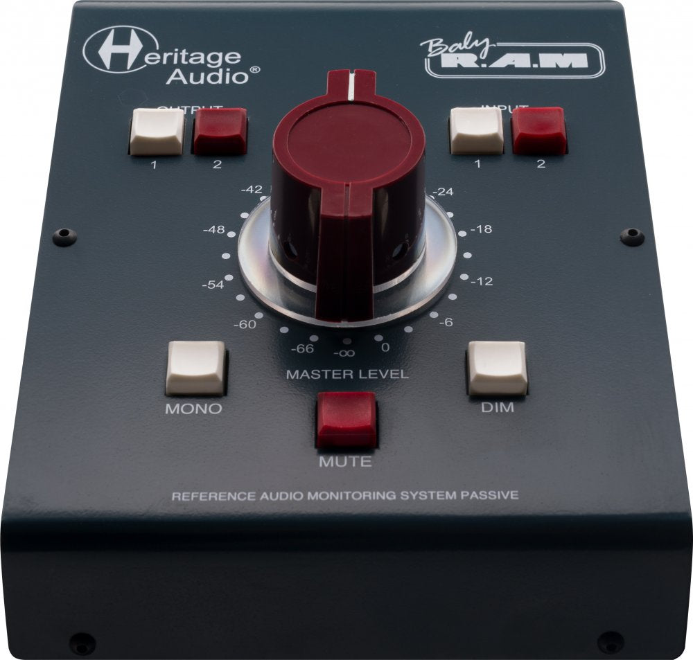 Black audio monitoring controller with large red rotary knob and multiple white and red buttons on top panel.