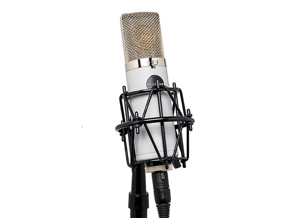 Silver condenser microphone with shock mount and attached cable on a stand against white background.