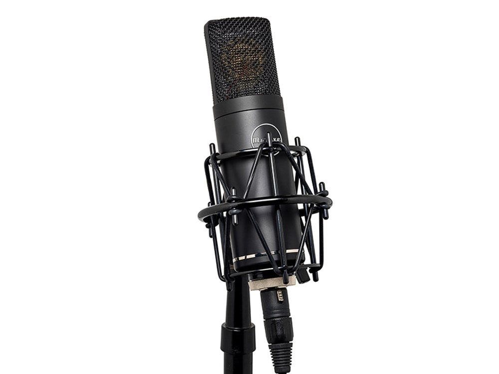 Black condenser microphone mounted in a shock mount on a microphone stand with XLR cable attached.