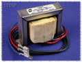 Metal transformer with fabric-wrapped coil and four wires ending in female terminal connectors on blue background