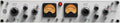 Silver panel audio device with knobs, toggle switches, two analog VU meters, and indicator lights.