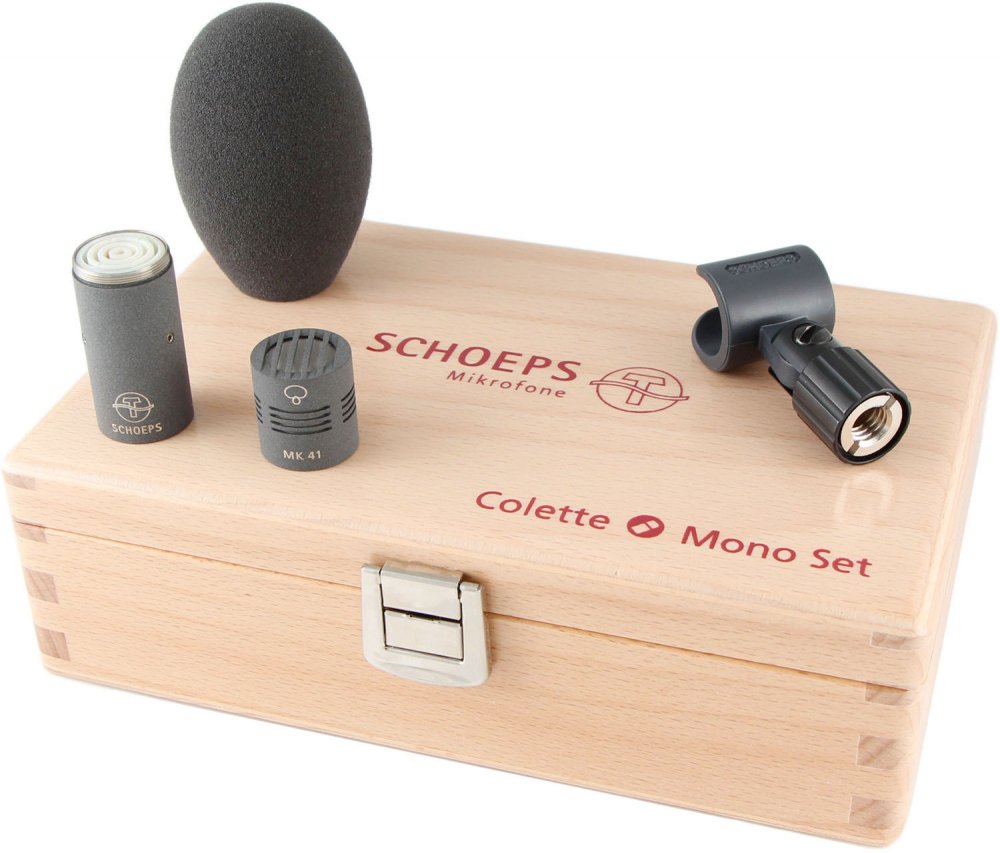 Microphone set including capsules, foam windshield, clip, displayed on a wooden box labeled Colette Mono Set