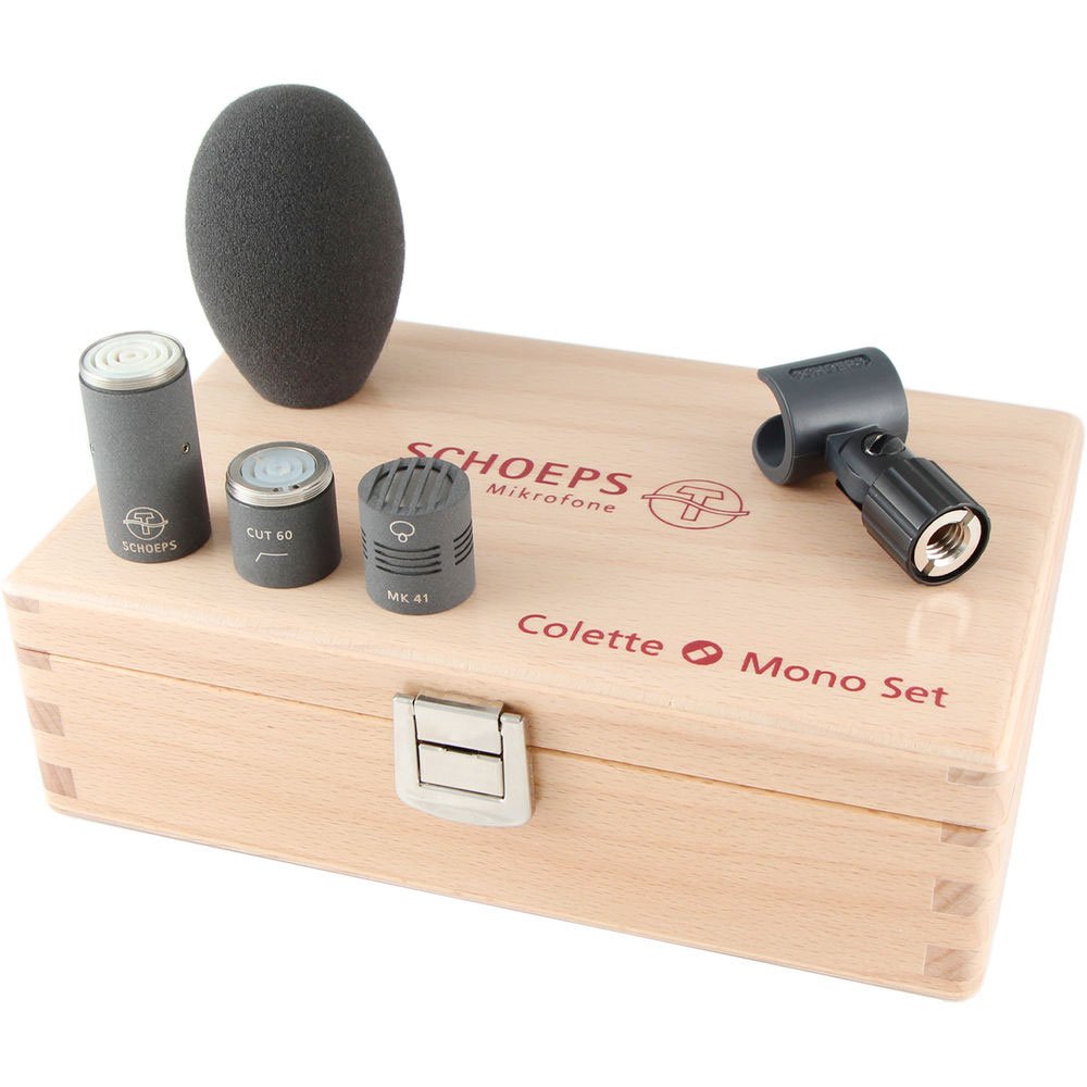 Microphone components including capsule, cut filter, foam windscreen, clip, and wooden storage box with engraved text.