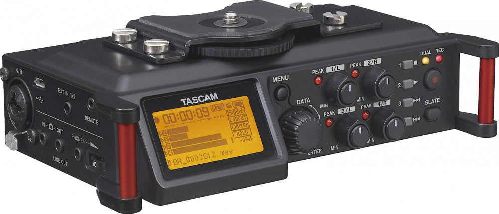 Black TASCAM audio device with screen, multiple control knobs, buttons, and various audio input/output ports.