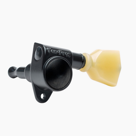 Black TonePros guitar tuner peg with cream tuning button on a white background.