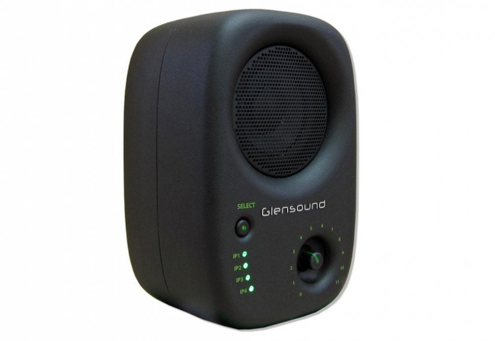 Black studio monitor speaker with round grille, rotary knob, push button, and green indicator lights.